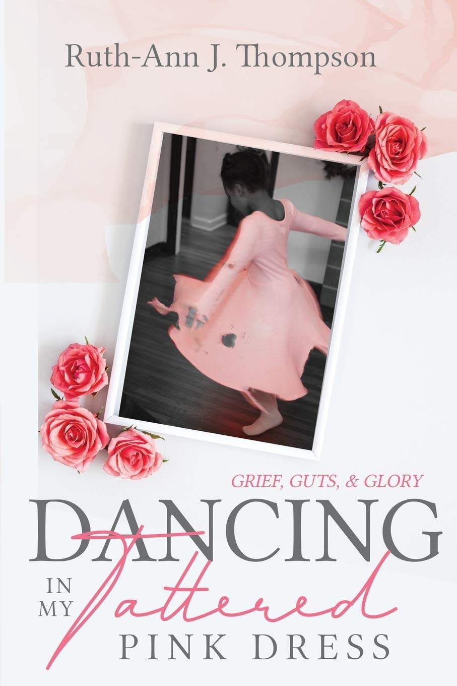 The cover of Dancing in My Tattered Pink Dress, showing a young girl mid-twirl in a pink dress, photographed in duotone with pink roses framing the image